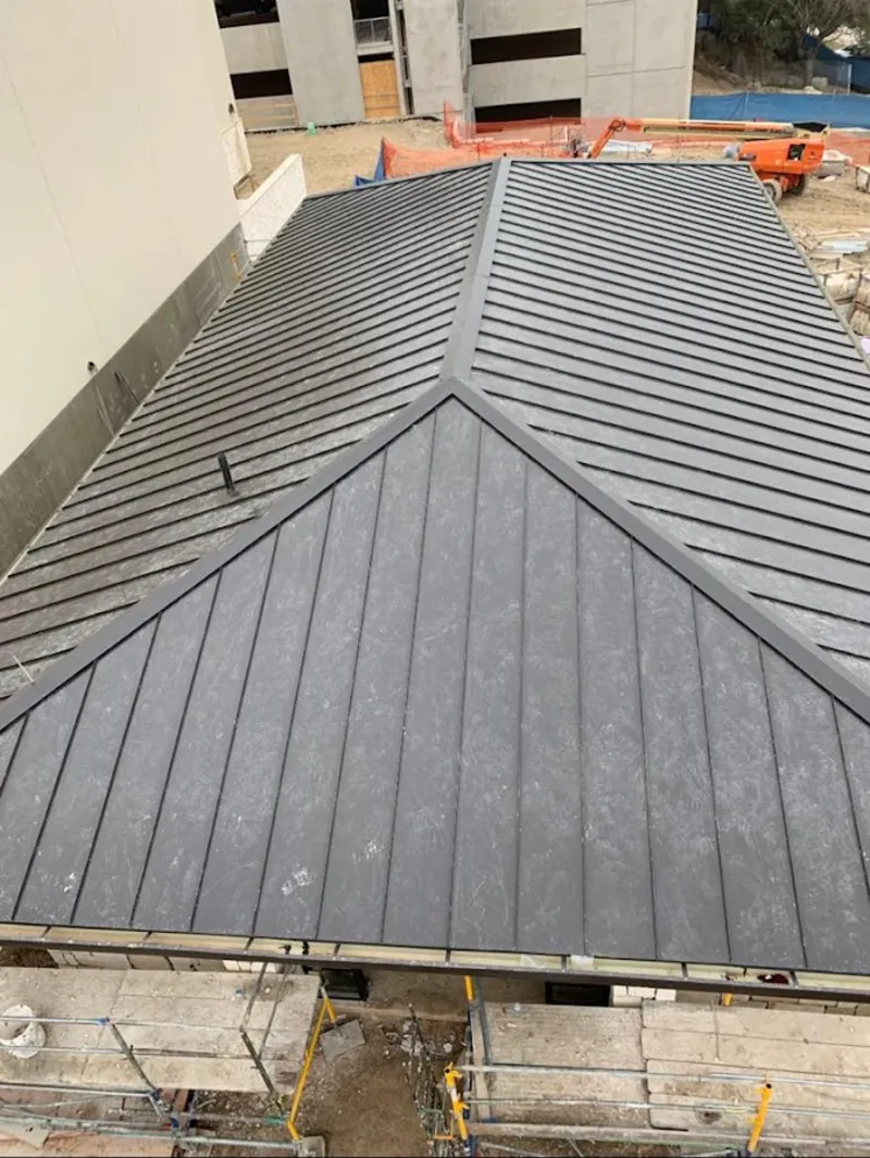 Commercial metal roof construction with crane equipment in Indiana