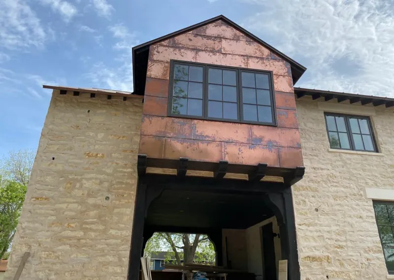 Copper metal panel facade on a stone building for Skylight Installation in Indiana