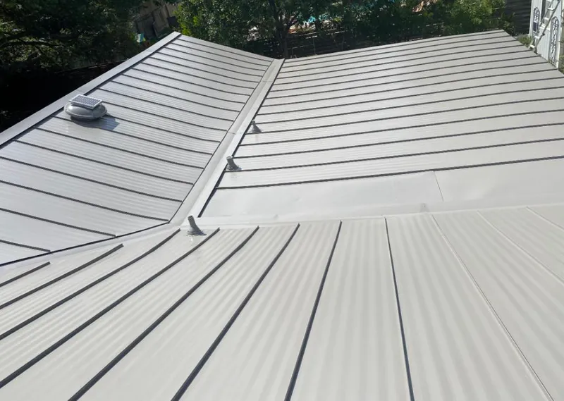 Solar attic fan installed on a metal roof for Roof Ventilation in Indiana